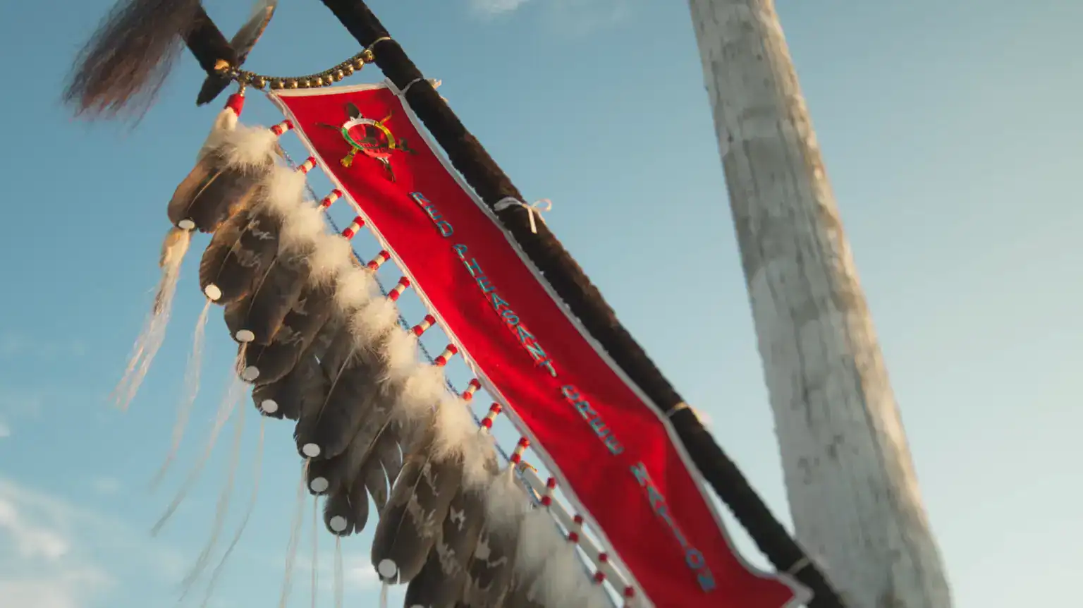 The Red Pheasant Cree Nation eagle staff against a blue sky
