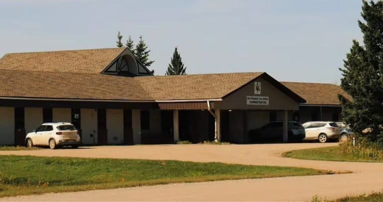 The Red Pheasant Cree Nation band office, with the Administration sign over the entrance and vehicles parked out front